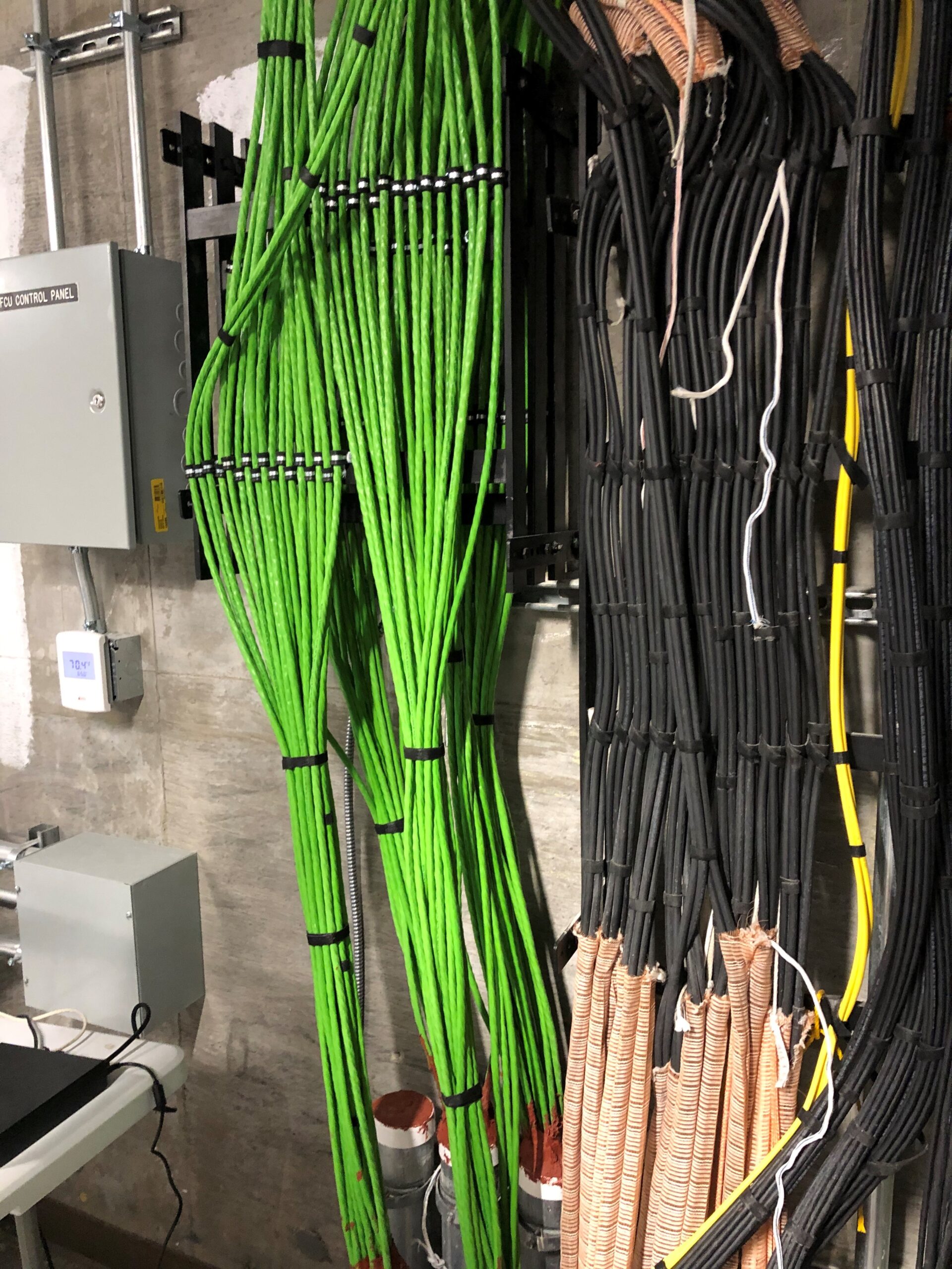 Vertically running green digital electricity cables